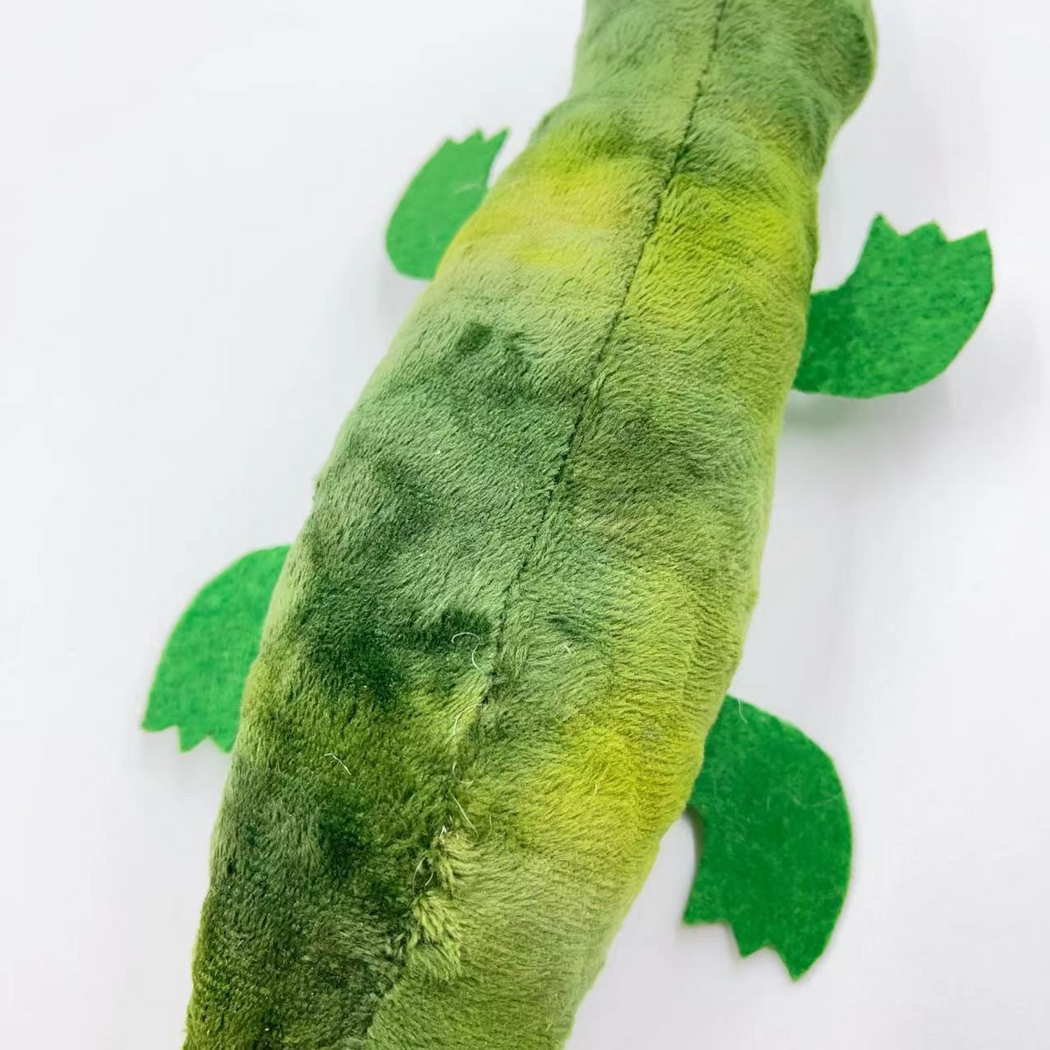 Close-up of the Crocodile cat toy showing green patches, the lengthwise seam and flat legs
