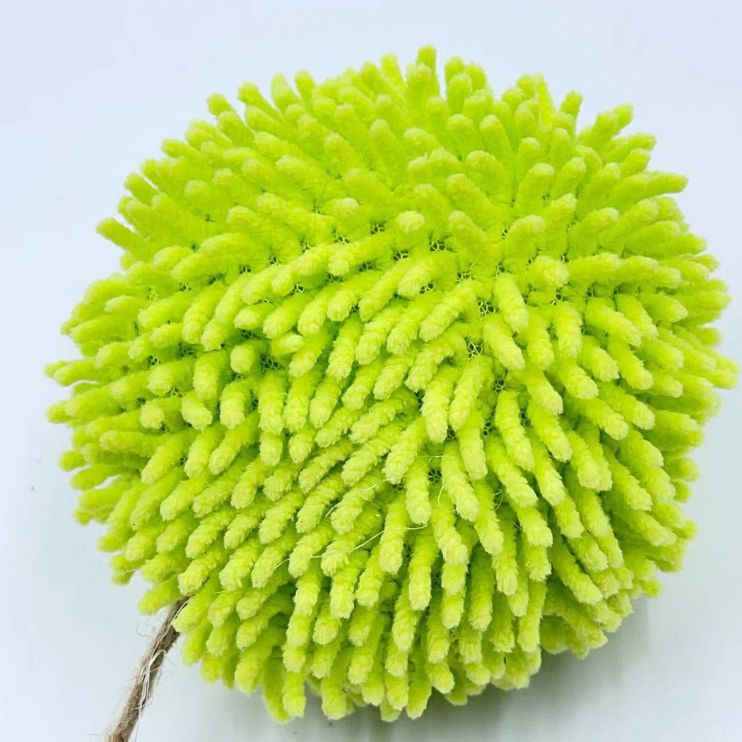 Rear close-up of the cat toy ball showing dense green tufts