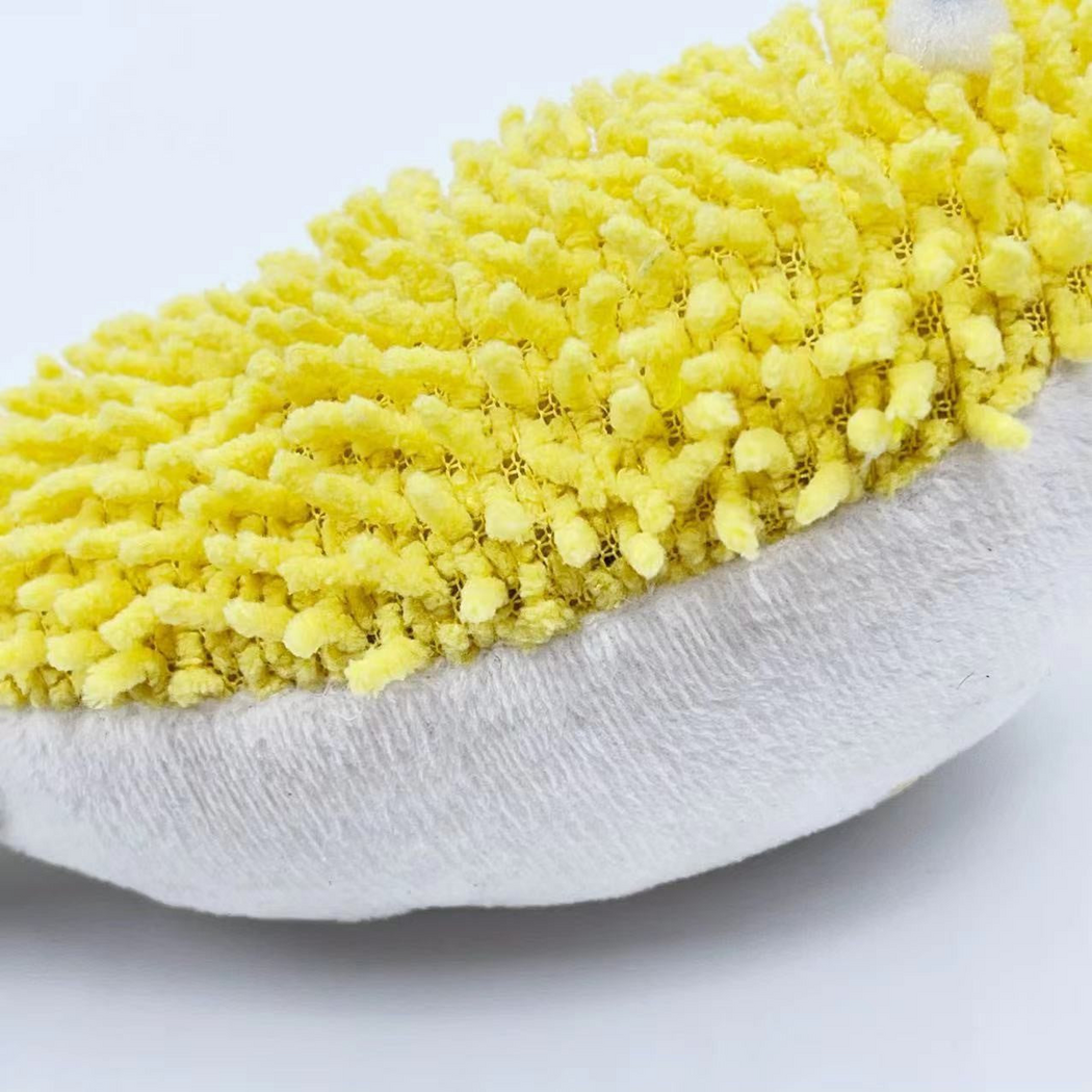 Close-up of the yellow tufted surface and white underside of the Pufferfish cat toy