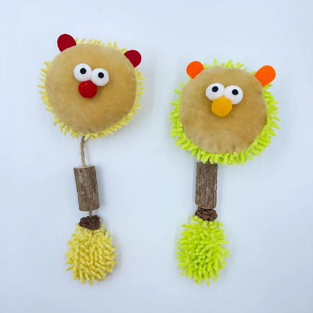 Yellow and Green lion-face cat toys displayed together with cord, bark-textured cylinders and fringed tails