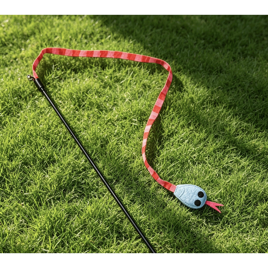 Red cat teaser toy detail; lower rod or rope end cropped