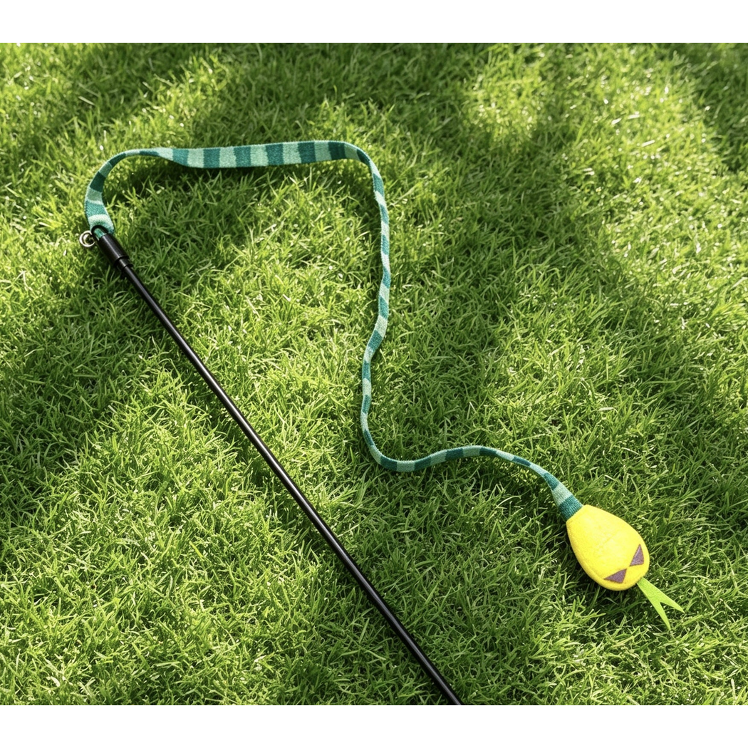 Green cat teaser toy detail; lower rod or rope end cropped