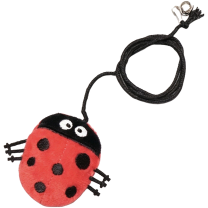 Close-up of a red ladybug attachment with spotted body, cord and clip