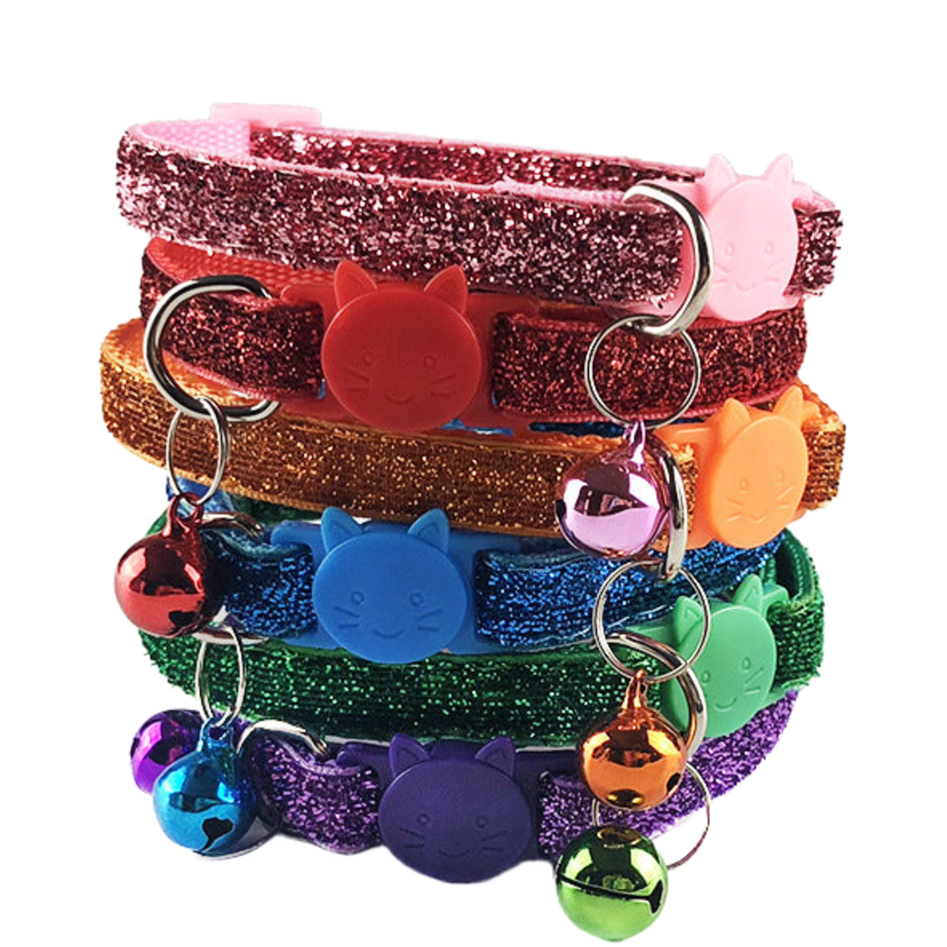 Glittery cat collars in six colors stacked together, with cat-face buckles and hanging bells