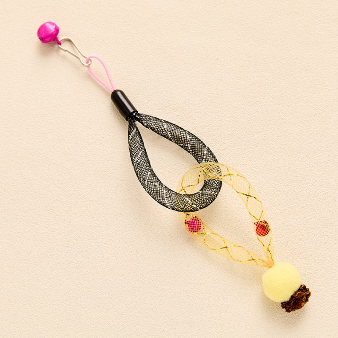 Close-up of Moo mesh tube cat toy showing bell inside