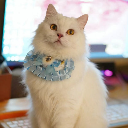 Close-up of Mokka cat neck bib showing detailed ruffle and gem embellishment