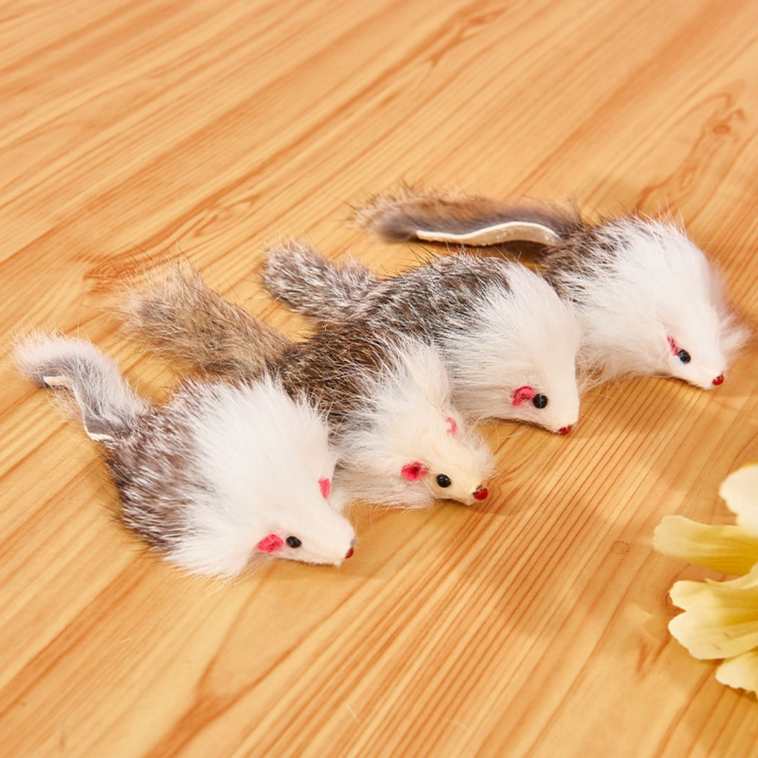 Close-up of Moo faux fur mouse cat toy in light brown with pink ears and tail