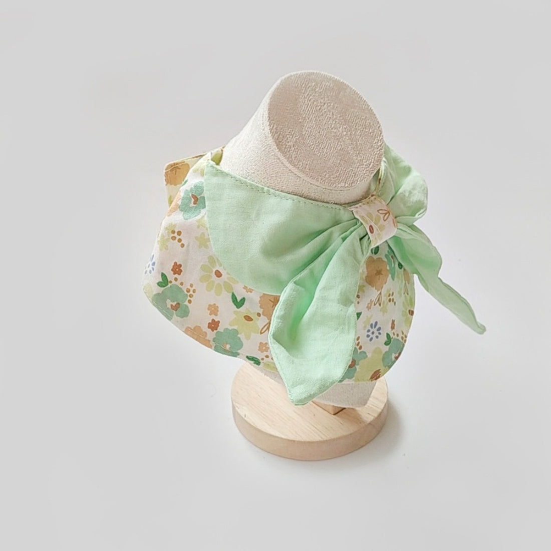 Close-up of Mokka cat neck bib fabric with detailed flower print