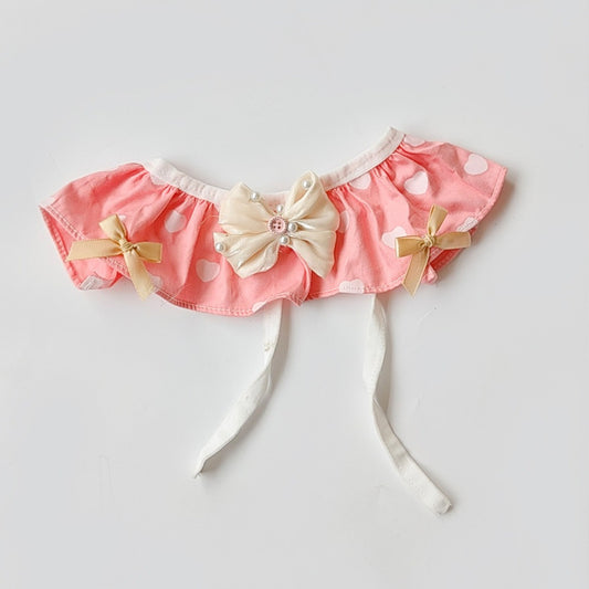 Close-up of heart-shaped bow detail on Mokka cat bib