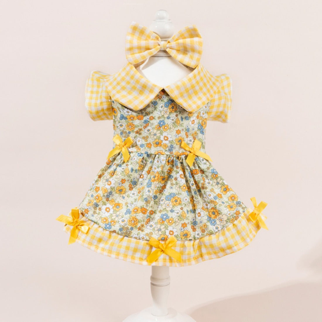 Back view of dog wearing Ozzie floral dress with large pink bow