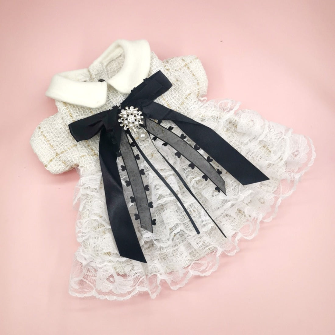 Close-up of Ozzie lace dog dress showing intricate floral lace pattern and bow
