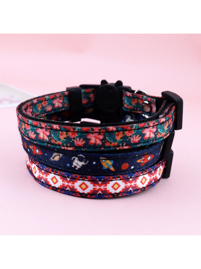 Mokka floral print bell cat collar displayed flat showing adjustable buckle and bell