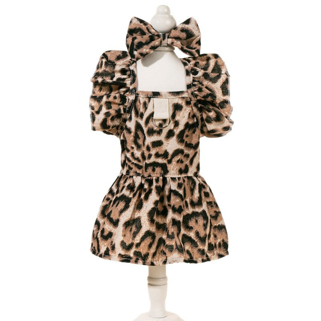 Back view of the dog wearing the leopard print dress with a bow
