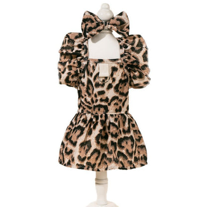 Back view of the dog wearing the leopard print dress with a bow
