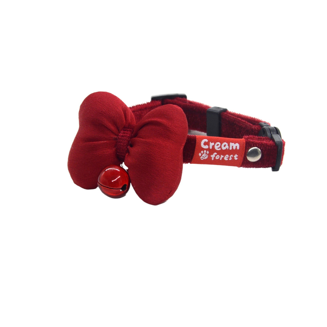 Close-up of red bow and small bell on breakaway cat collar