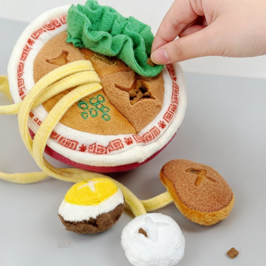 Close-up of Snuffy Ramen Snuffle Puzzle Dog Toy showing textured noodle fabric