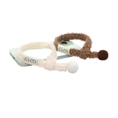 Close-up of Mokka cat collar showing soft pom pom and metal bell detail