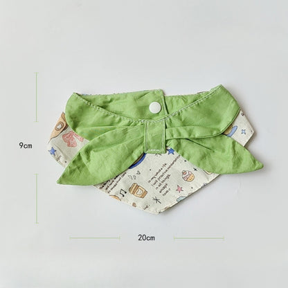 Mokka bib worn by baby featuring vibrant cartoon cat print