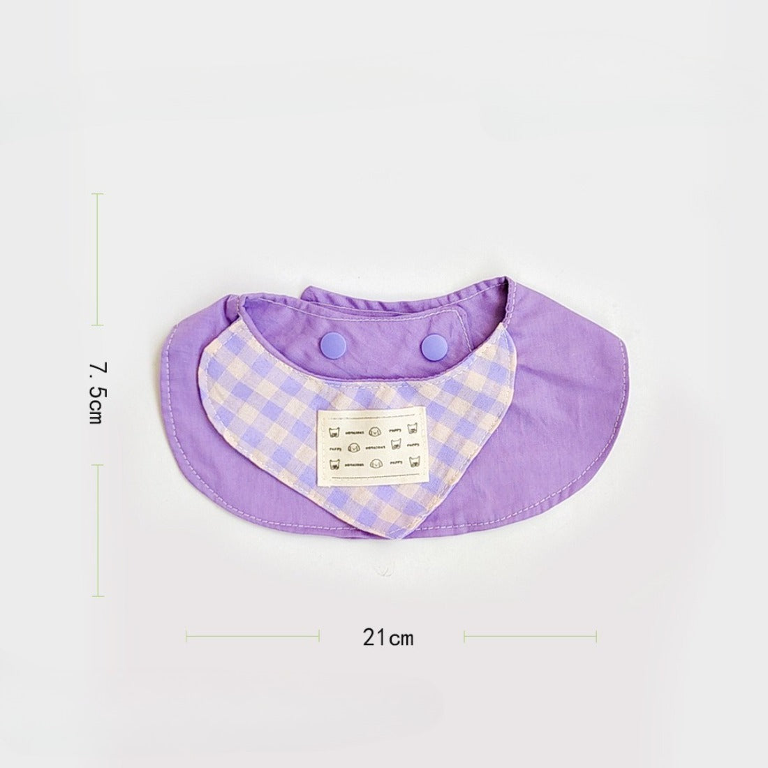 Close-up of pastel gingham cat bib showing soft fabric texture and stitched edges