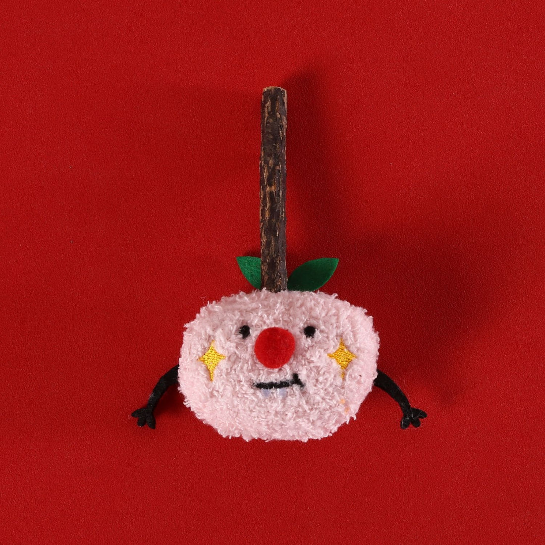 Moo cat plush toy with festive face on plain background