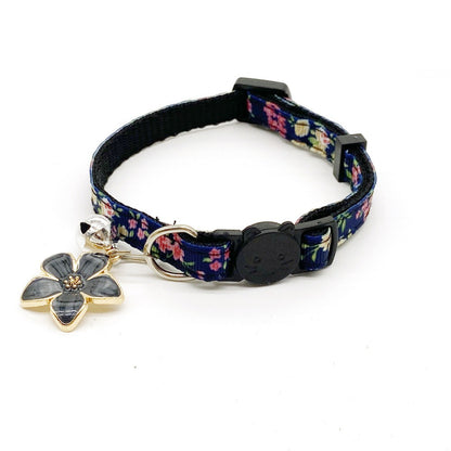 Cat wearing Mokka floral bell charm collar with pink flowers and green leaves