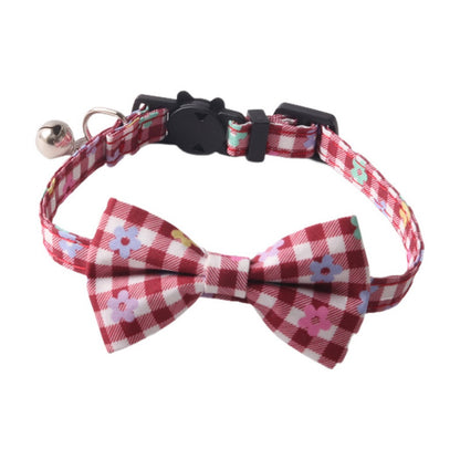Mokka cat collar with floral bow tie laid out to show adjustable buckle and strap length