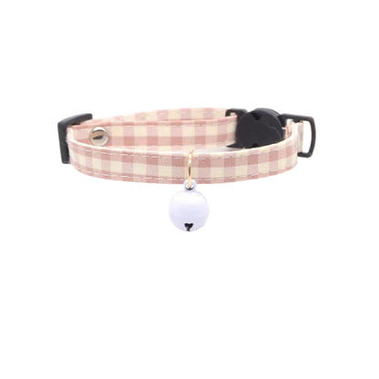 Mokka gingham cat collar displayed on a wooden surface with a soft focus background