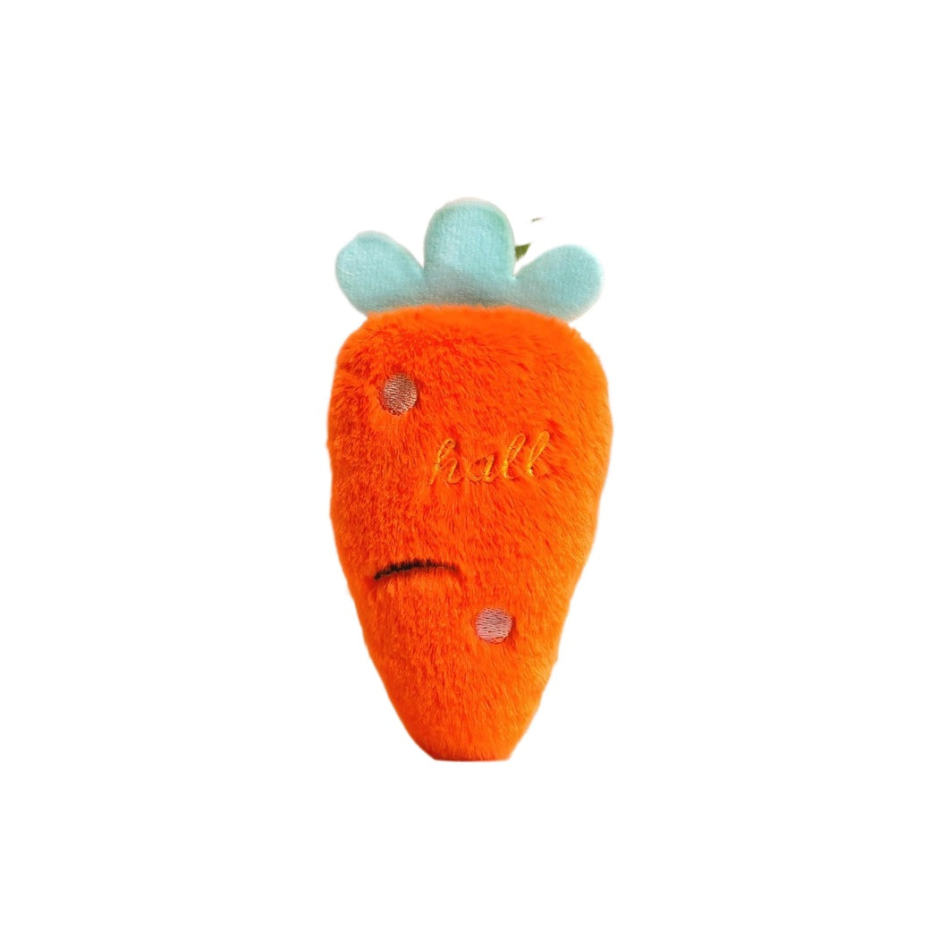 Petkin Carrot Plush Squeaky Dog Toy laying flat with green top facing up