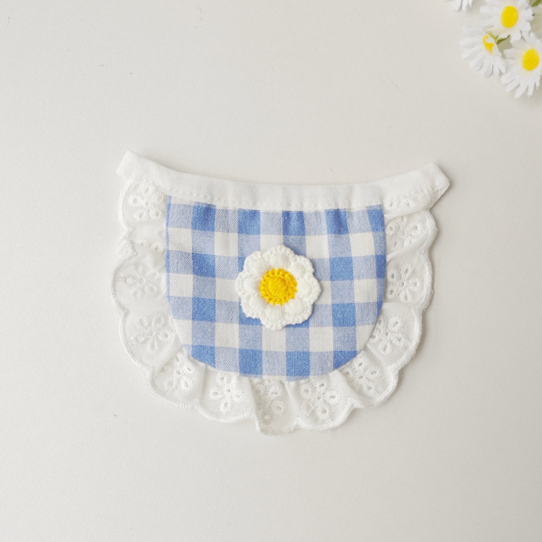 Close-up of Mokka gingham daisy cat bib showing detailed fabric and flower design