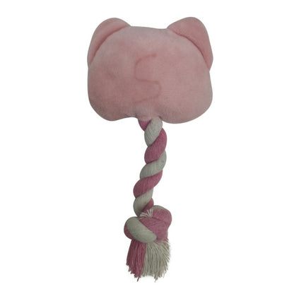 Close-up of pink pig dog toy showing textured rope and stitched facial features