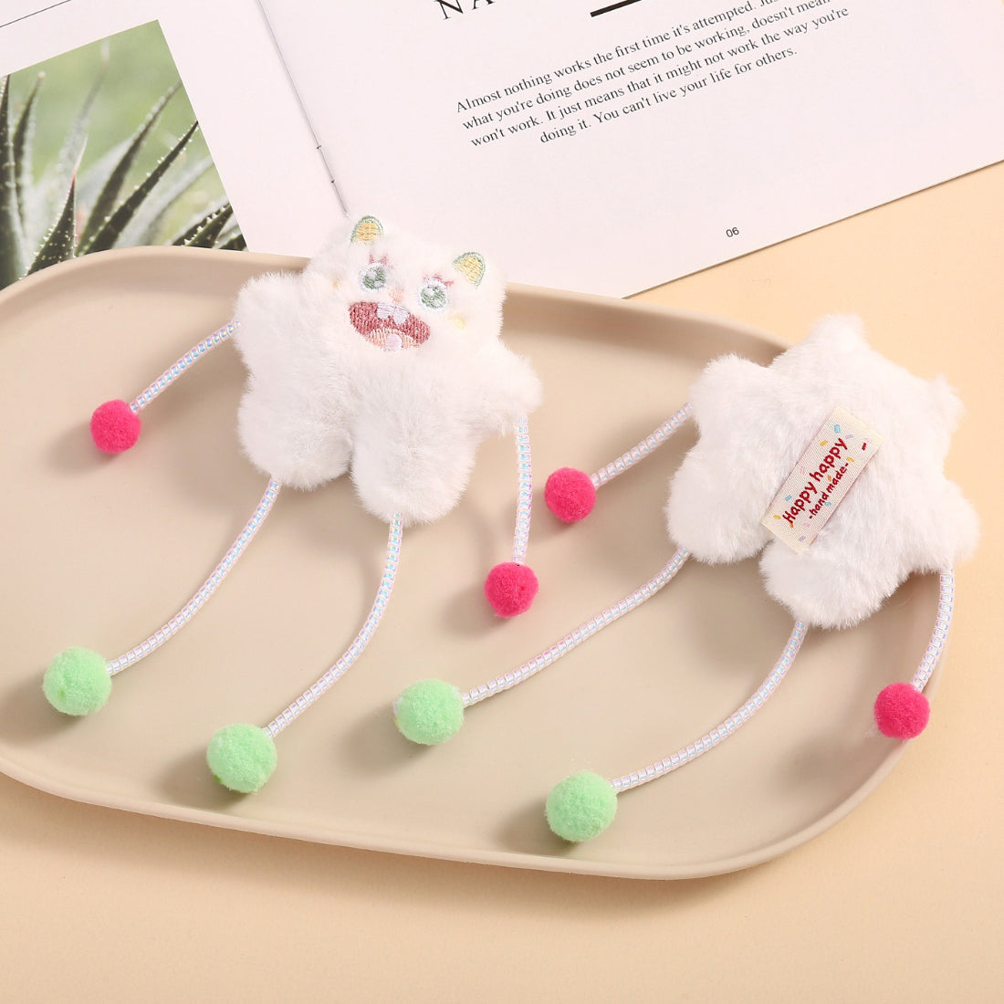Moo dangling plush cat toy with colorful pom poms on a string