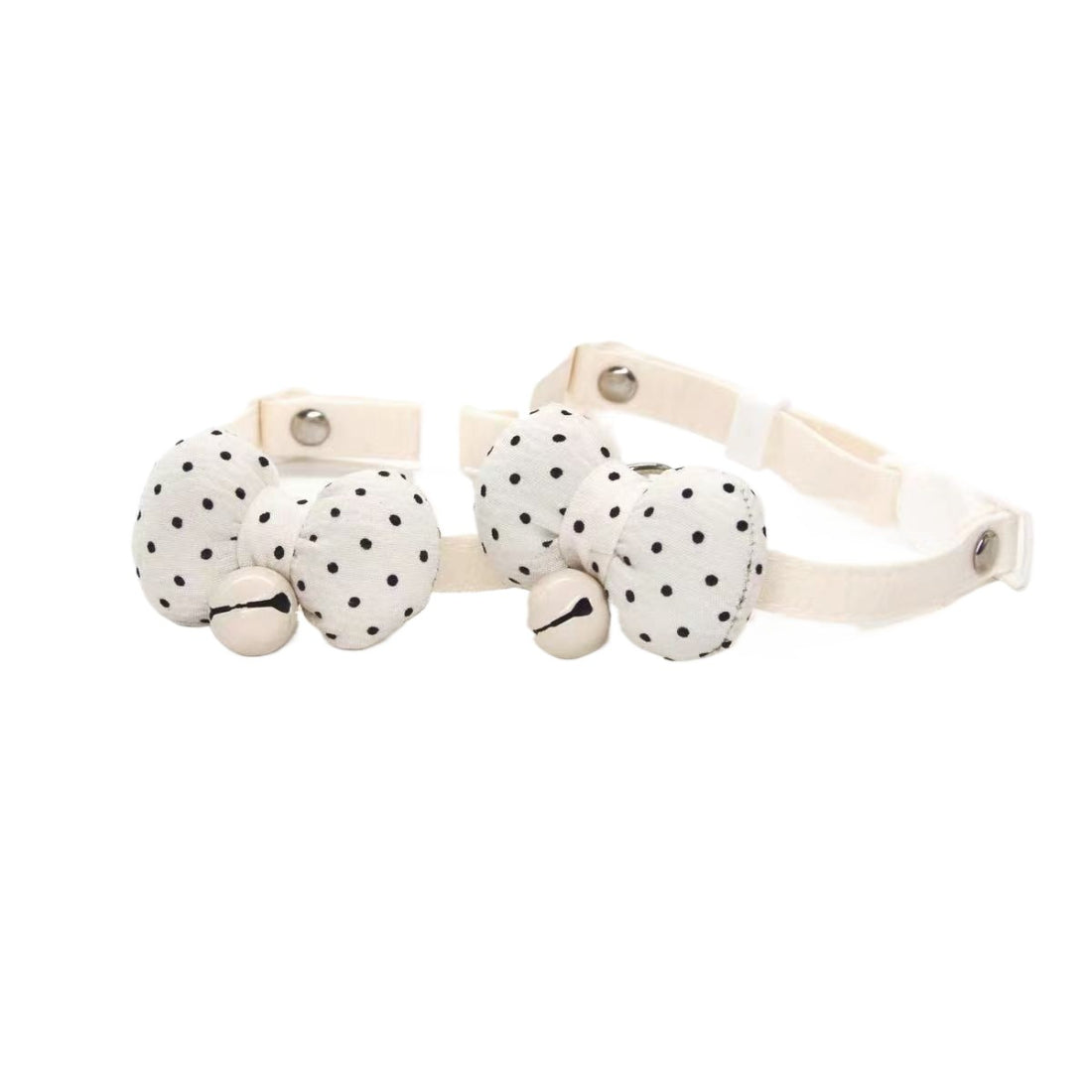 Mokka cat collar with white polka dot bow and breakaway safety clasp on a brown strap