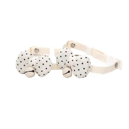 Mokka cat collar with white polka dot bow and breakaway safety clasp on a brown strap