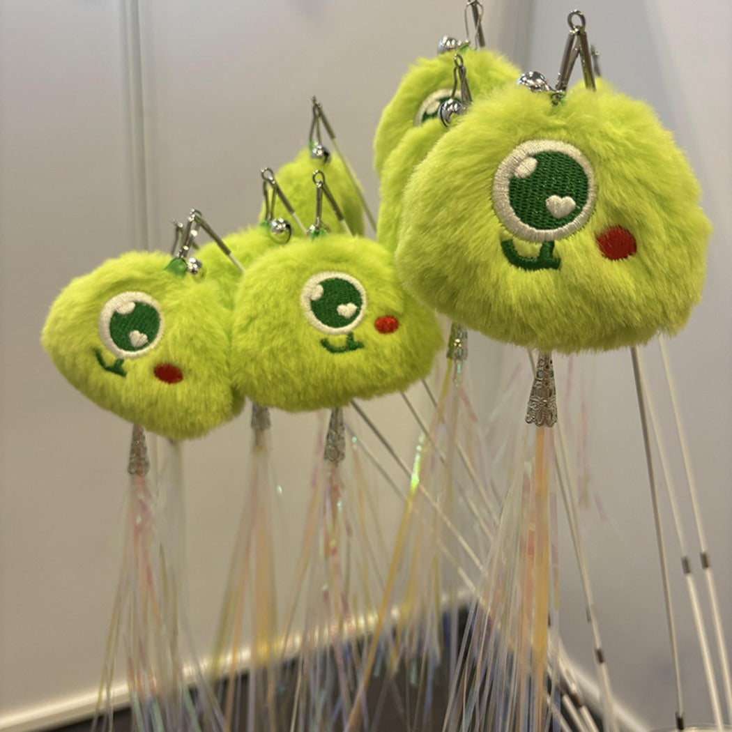 Close-up of Moo interactive cat toy pom figure attached to telescopic wand