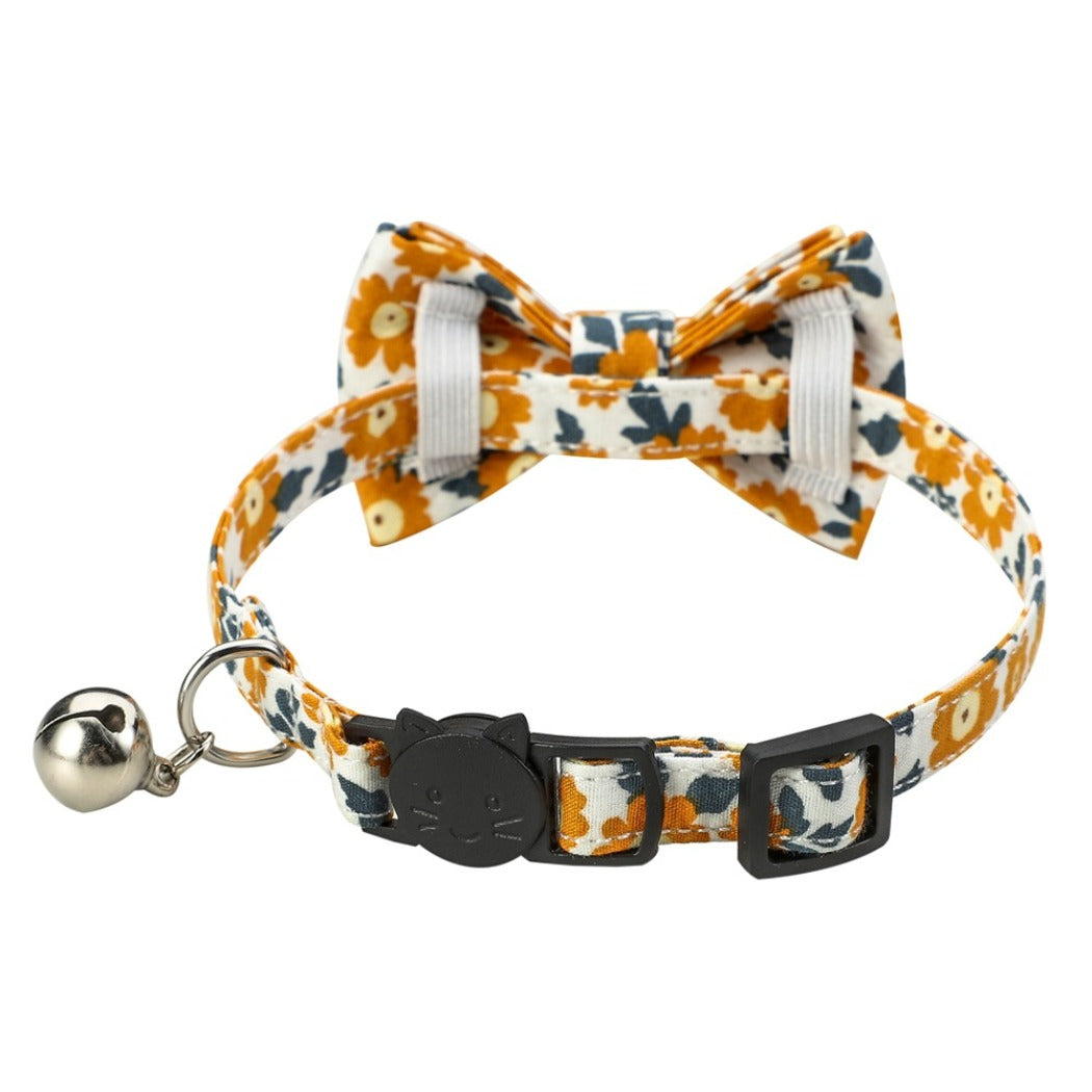 Mokka floral bowtie cat collar photographed on a flat surface with clear floral print