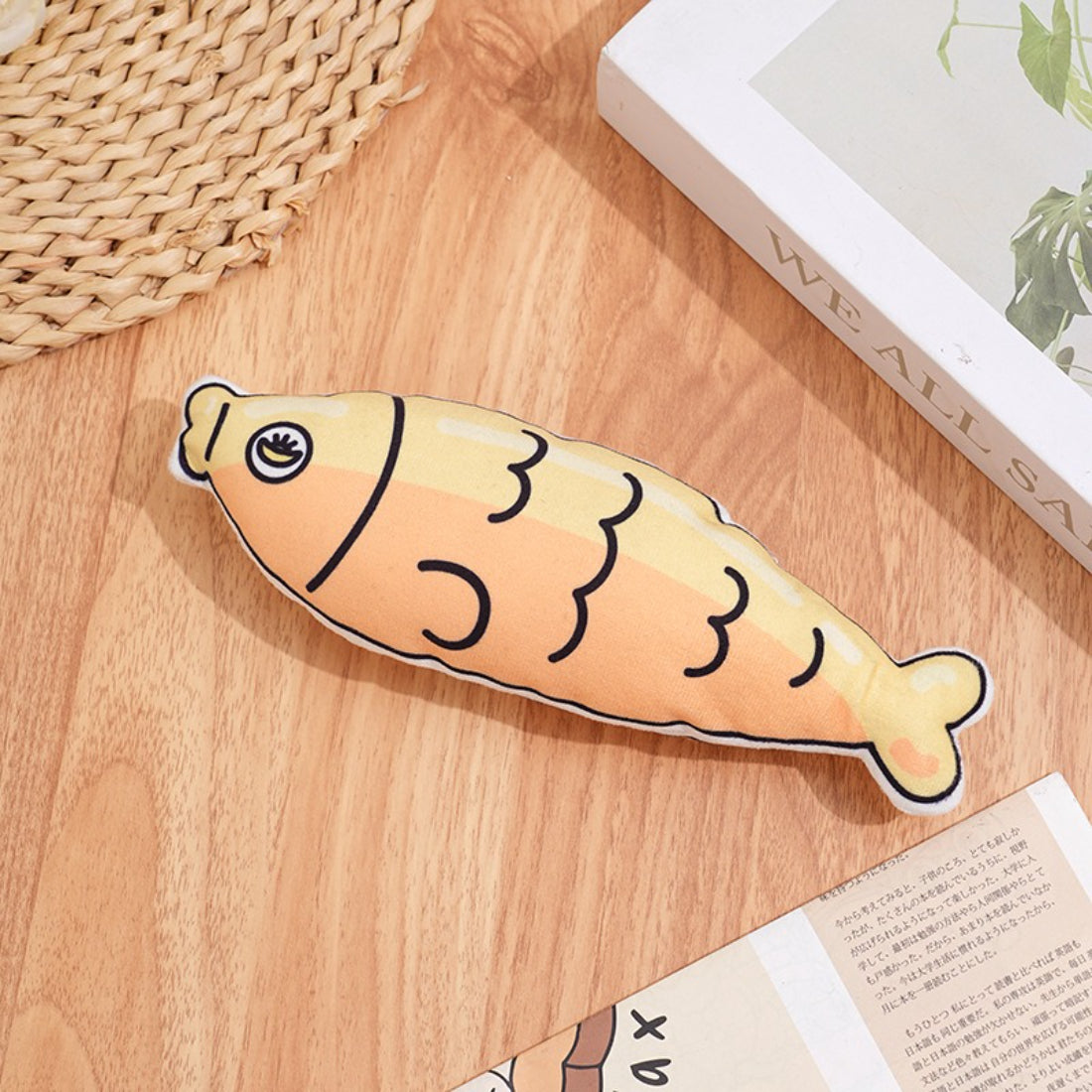 Moo plush cat toy lying on a wooden surface with visible tail and ears