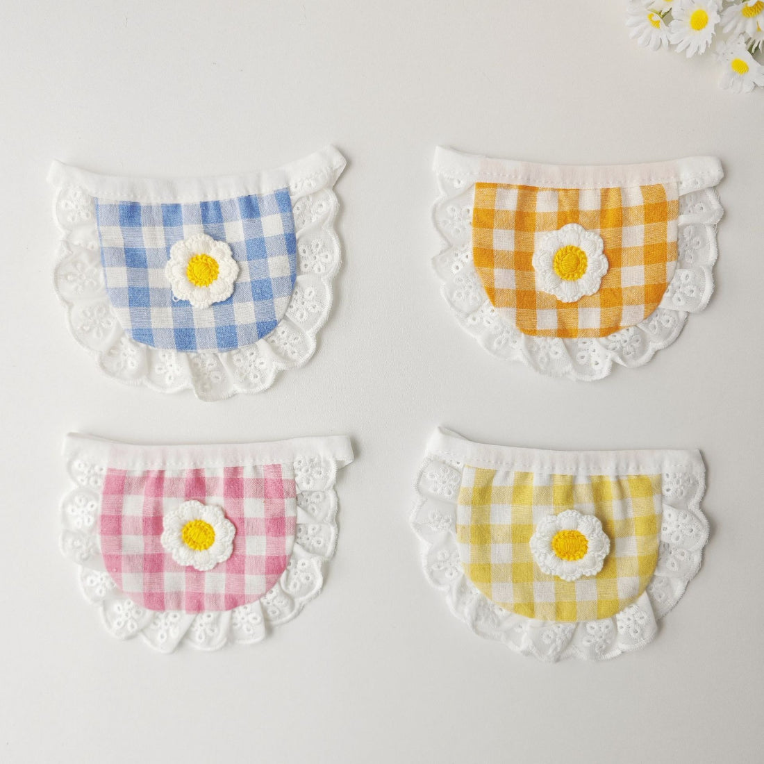 Mokka gingham daisy cat bib with pink and white checkered pattern and floral accents