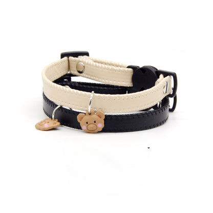 Close-up of bear charm on brown leather cat collar with breakaway safety clasp
