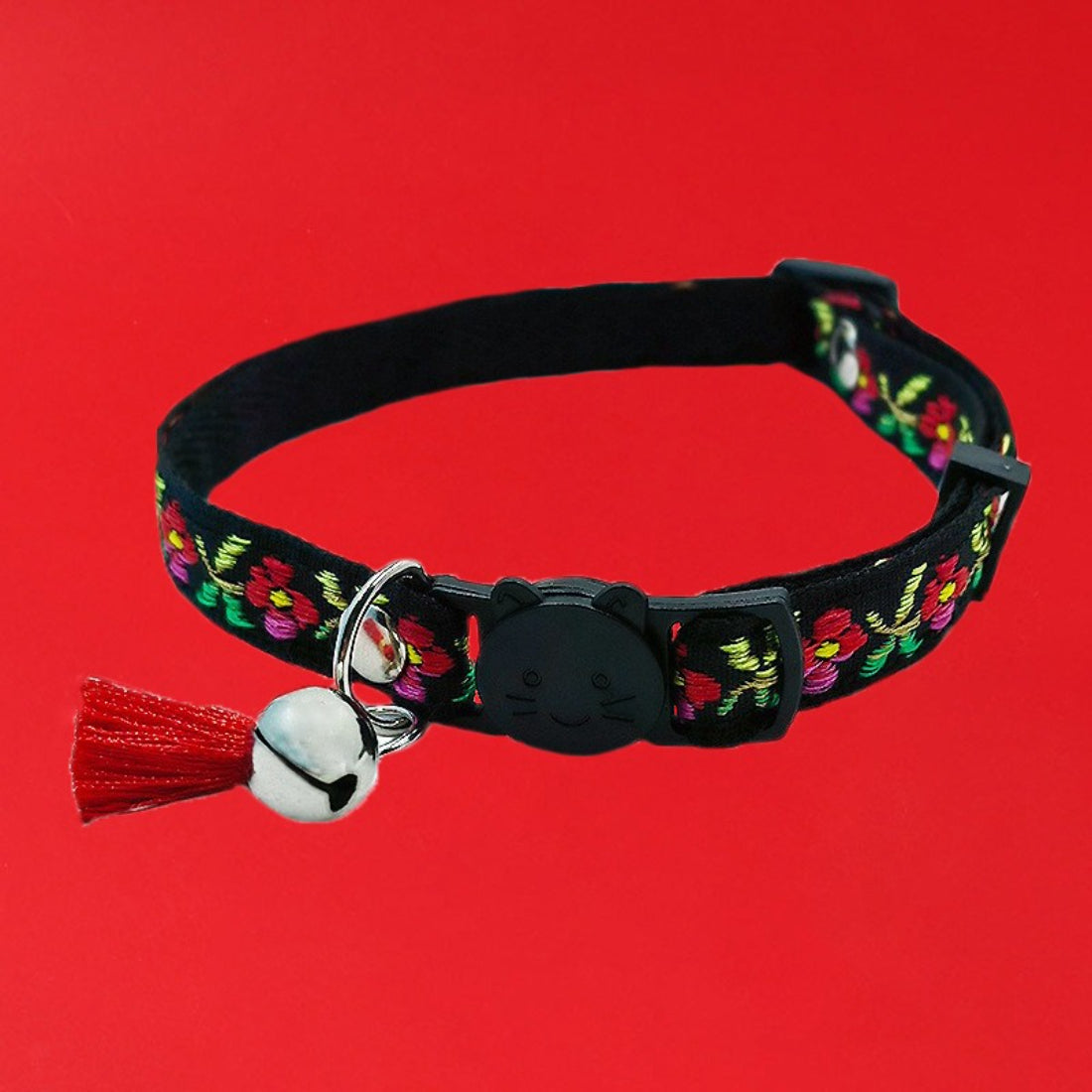 Mokka cat collar with vibrant floral pattern and attached bell laid flat