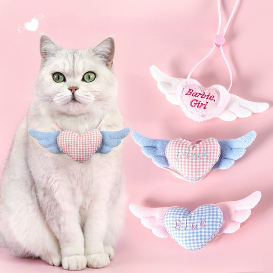 Close-up of Mokka Winged Heart Charm Cat Collar with heart-shaped charm on a white background