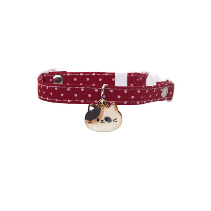 Close-up of Mokka cat face charm attached to pink collar with bell