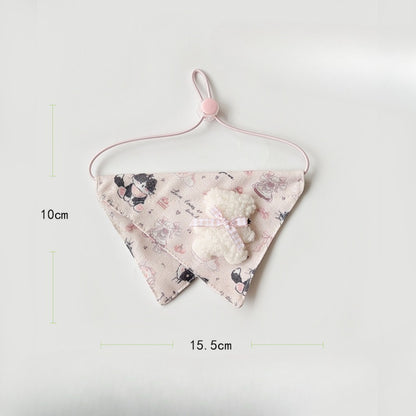Pink baby bib with cartoon cat design laid flat on white background