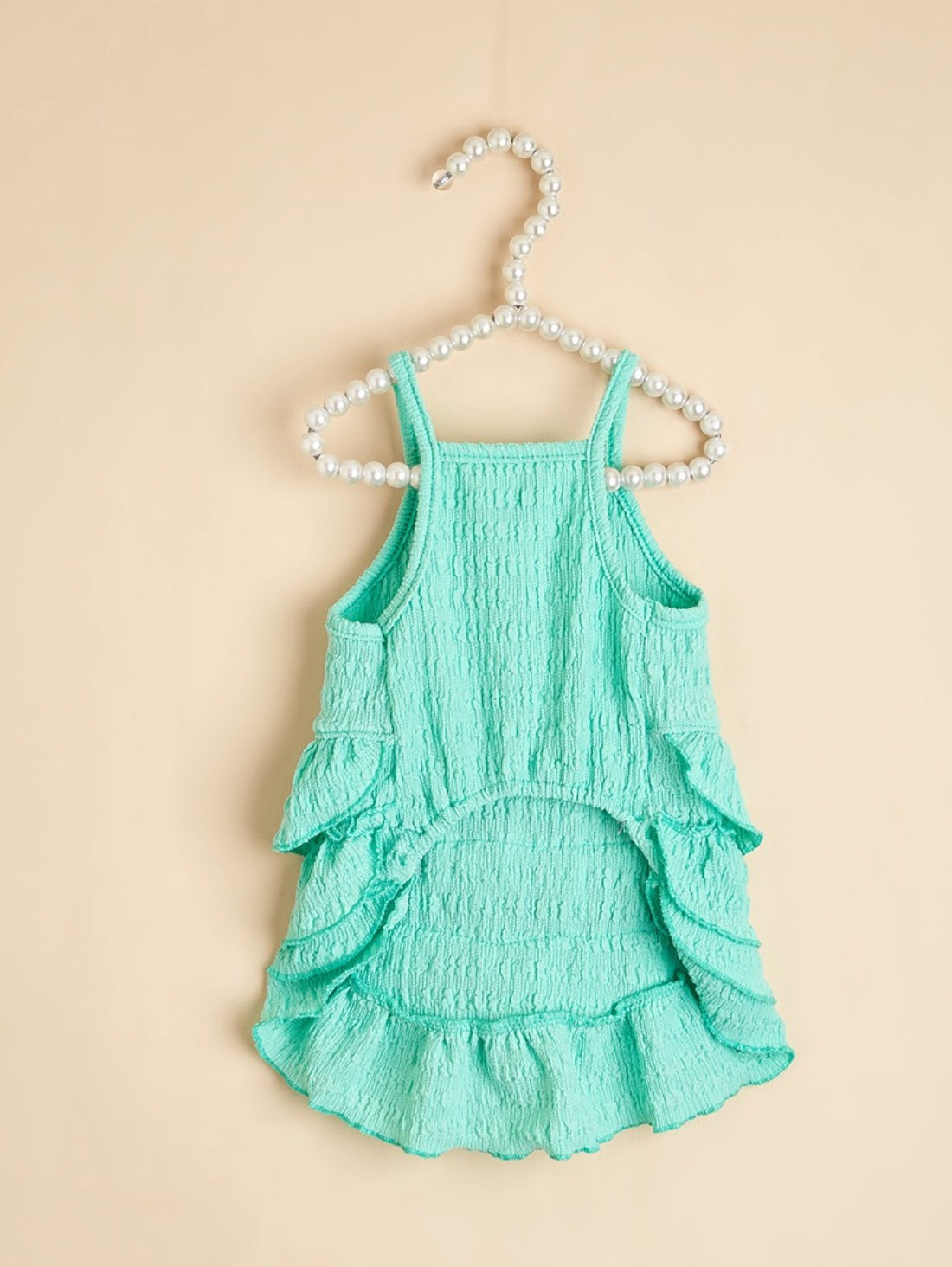 Close-up of bow detail on Ozzie summer ruffle dog dress in pink fabric
