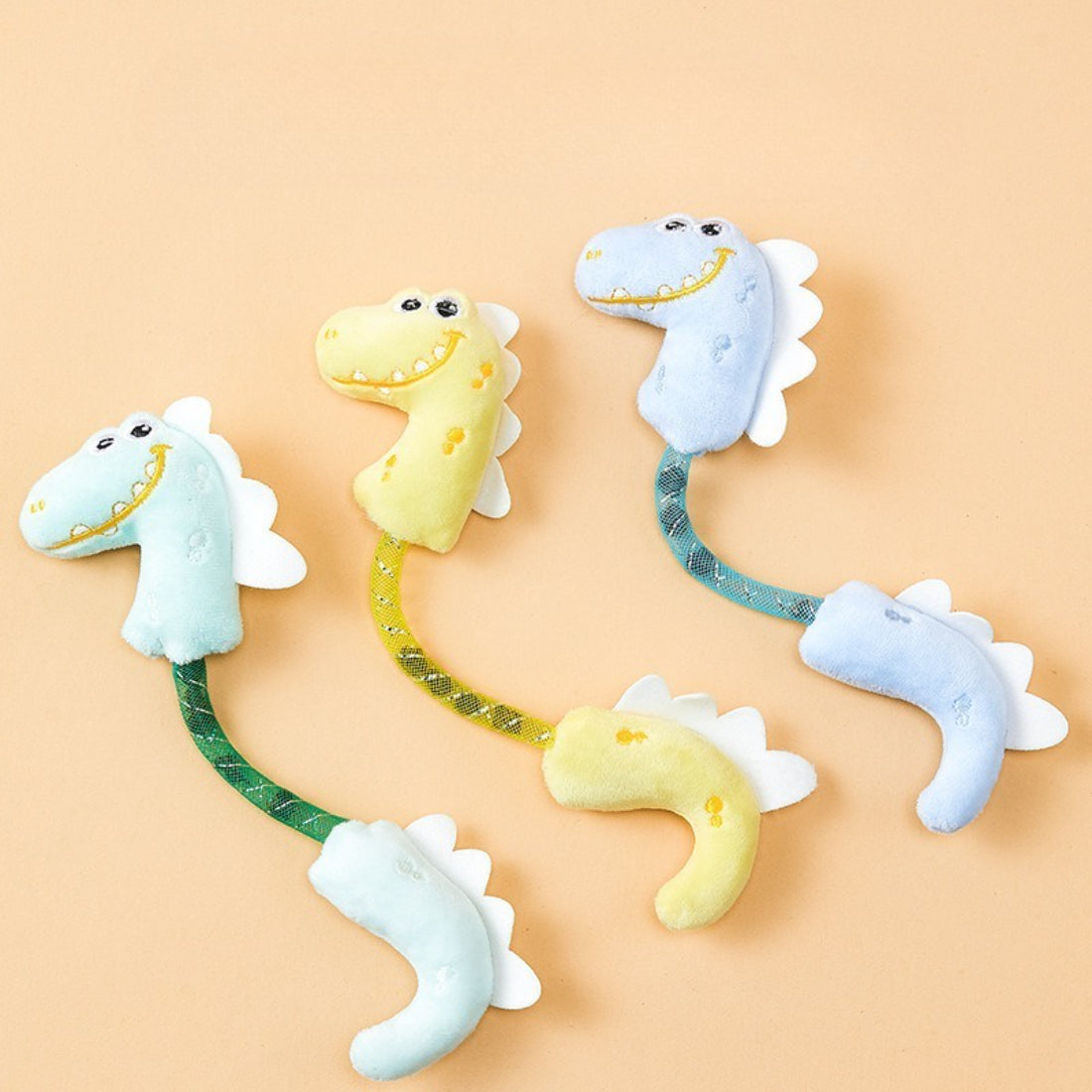 Moo dinosaur plush cat toy in green with orange spikes and white belly