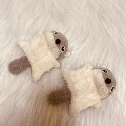 Plush squirrel kicker cat toy held in hand to show size and softness