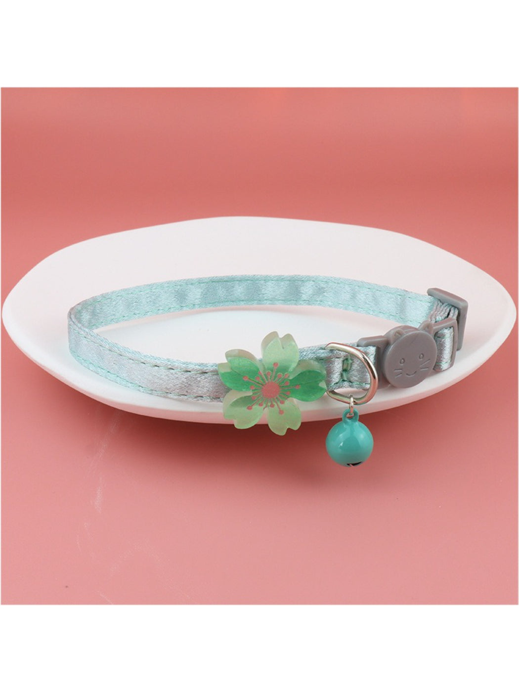 Detailed shot of bell and clasp on pastel flower cat collar named Mokka