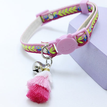 Side view of Mokka floral pattern cat collar with attached tassel and bell