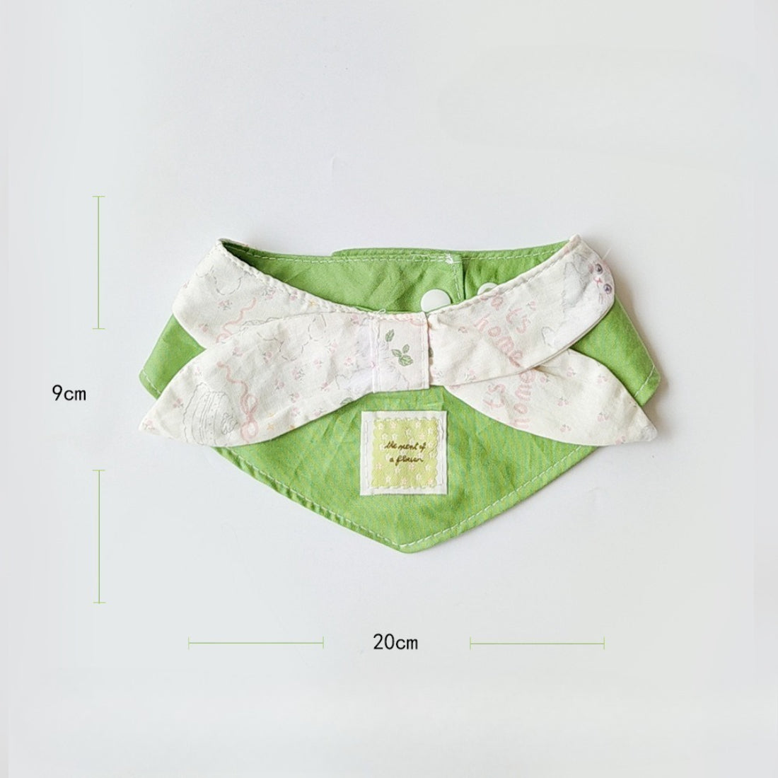 Soft green cat neck bib displayed flat showing full shape and size
