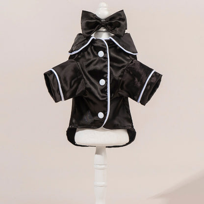Close-up of the bow detail on the satin dog shirt worn by a small dog