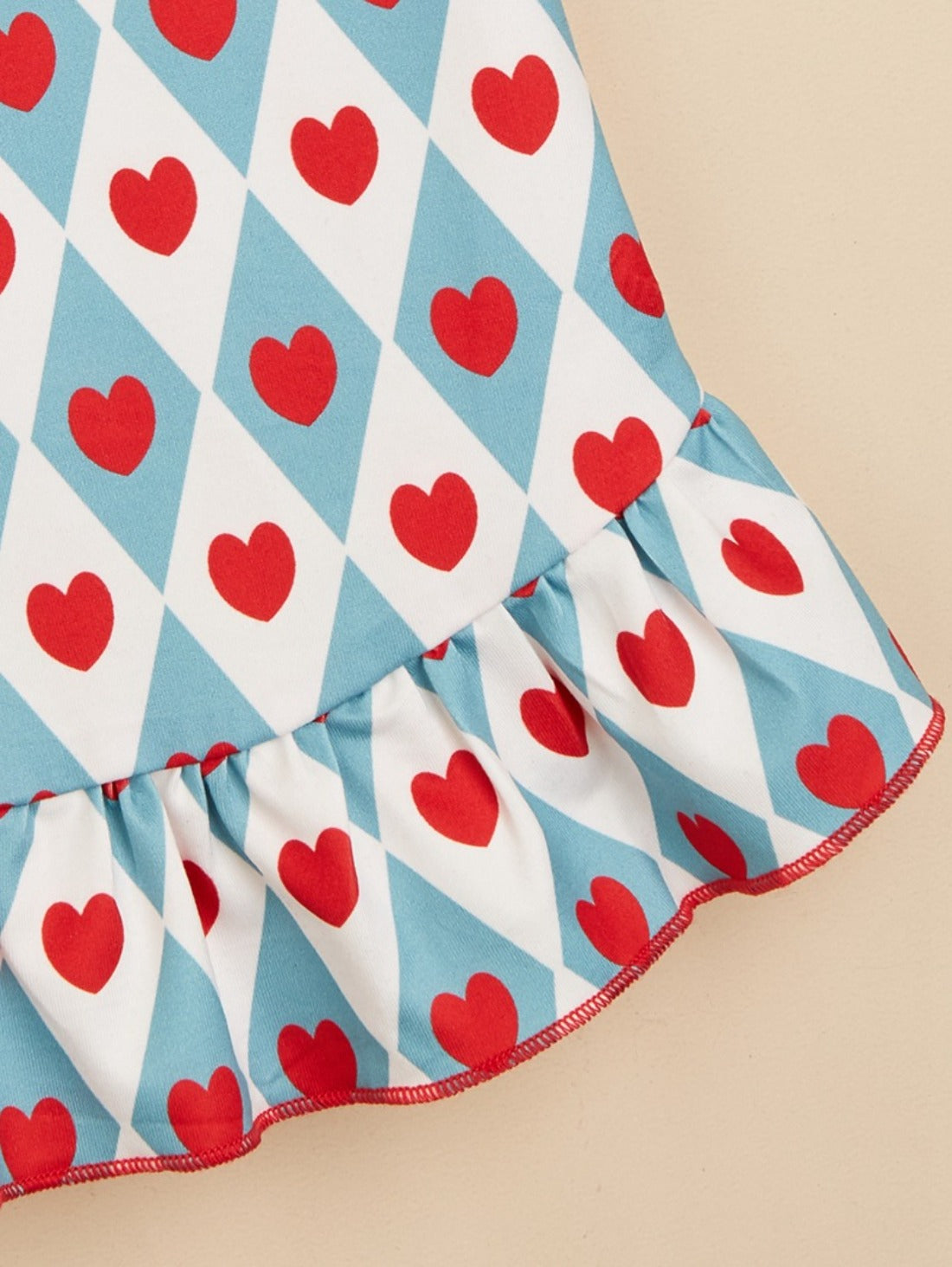 Small dog walking outdoors wearing Ozzie cute heart pattern dress